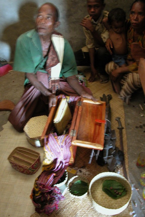 In the district of Maubaru, villagers carefully place the swords, tapestries and jewelry of generations past nside the Umu Lulik, or sacred house.(Photo by Maria Bakkalapulo)